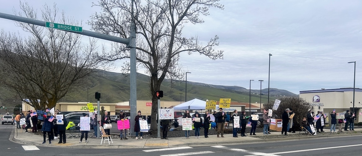 Protesters line the intersection of Bridge St and 5th St in Clarkston, WA on January 11, 2026.