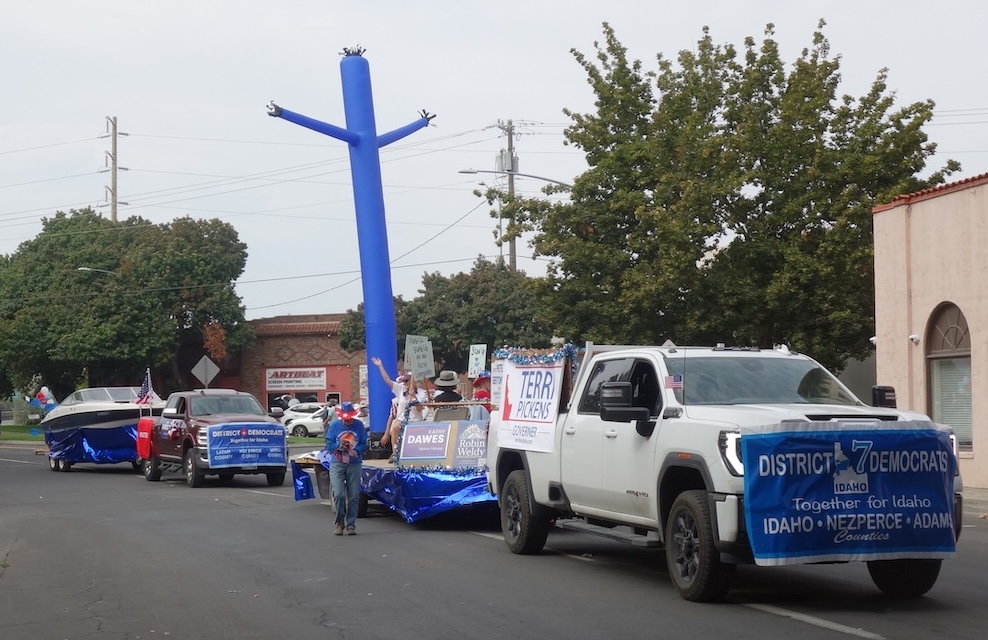 Two trucks, a trailer with supporters and a large blue inflatable man, and a boat - the caravan rolls onto Main Street.
